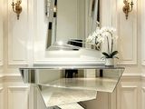 a glass table with a mirror on it in a room