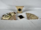 a small clock and a lot of money sitting on a table