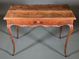 an old wooden table with a drawer on top of it