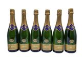 six bottles of champagne are lined up in a row