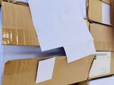 a man standing in front of a bunch of boxes