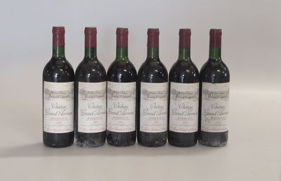 six bottles of wine are lined up on a table