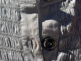 a close up of a dress with buttons on it