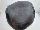 a black bean bag sitting on top of a toilet