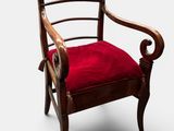 une image représentant une chaise avec un coussin rouge sur fond blanc