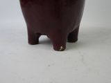 a small brown elephant statue on a white surface