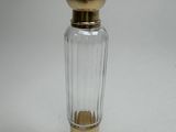an image of a small glass bottle with a gold top