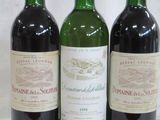 trois bouteilles de vin posées l'une à côté de l'autre sur une table