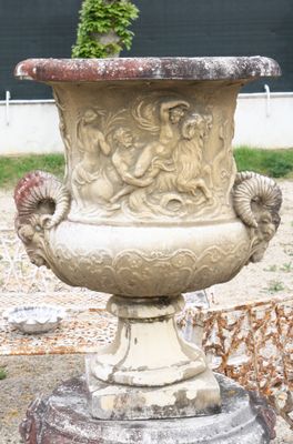 a large stone vase sitting on top of a stone pedestal