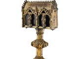 an image of a gold cup with a statue of a man and a woman on it