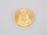 an image of a gold coin sitting on top of a white surface