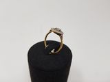 a close up of a gold and diamond ring on a black box