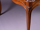an old wooden table with a wooden top on a grey background