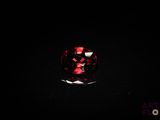 a close up of a red diamond on a black surface