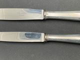 two knives that are sitting next to each other on a table