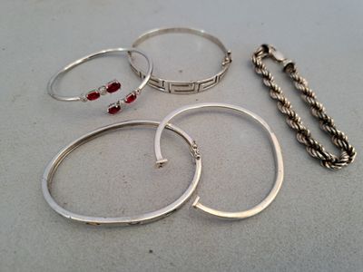 four rings and a bracelet on a table
