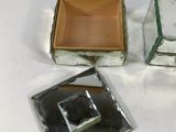 three square glass boxes sitting on a white surface