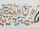 a collection of costume jewelry including brooches, bracelets, earrings, and rings