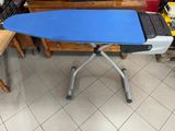 a blue and white ironing board sitting on top of a blue ironing board