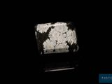 a black and white photo of a rock in the dark
