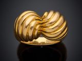 a close up of a gold ring on a black surface