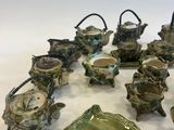 many pieces of pottery that are sitting on a table
