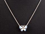 un collier avec un pendentif en forme de papillon sur un mannequin, un mannequin, un mannequin, un mannequin, un mannequin, un mannequin, un mannequin, un mannequin