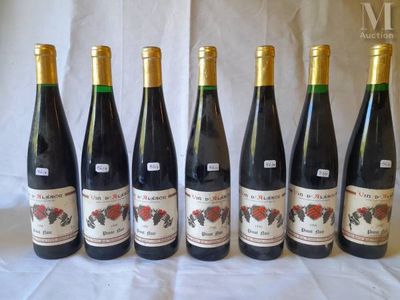 six bottles of wine are lined up on a table