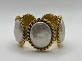 a close up of a ring with a pearl on it