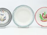 three plates with different designs on them on a white surface