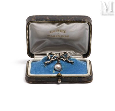 a box with a broochee and a ring inside of it