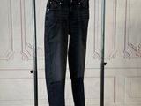 an image of a pair of jeans hanging on a clothes rack