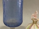 three glass vases sitting next to each other on a table