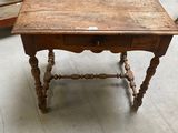 a small table with a drawer on top of it