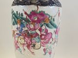 a vase with a design on it sitting on a table