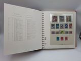 an open book with stamps on it sitting on a table