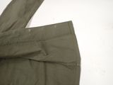 the bottom of a pair of olive green pants on a white surface