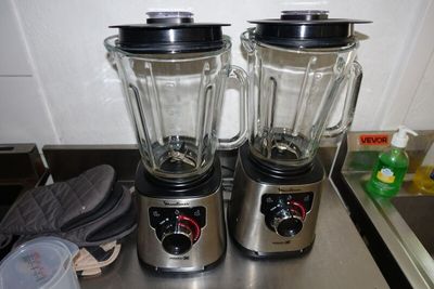 two blenders that are sitting on top of a counter