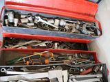 many tools in a red toolbox on the floor