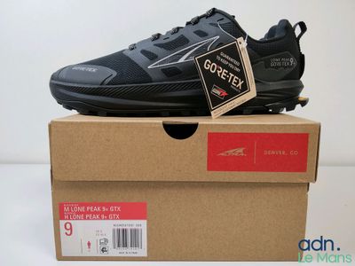 the box is open and the shoe is on top of the box