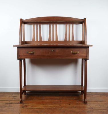 a wooden desk with a drawer underneath it on a hard wood floor