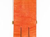 an orange cloth hanging on a white wall with a wooden pole