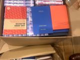 many books in the box on the table