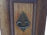 a small wooden cabinet with a metal handle on it