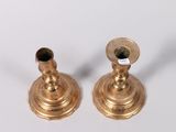pair of antique brass candlesticks on a white background