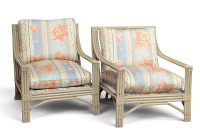 pair of rattan chairs with floral upholstered cushions