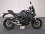 a picture of a black motorcycle parked on a checkered floor