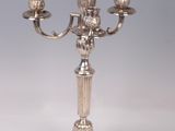 a silver candelab with three candles on it