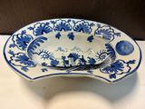 a blue and white bowl with a spoon in it