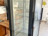 a glass display case in the middle of a kitchen